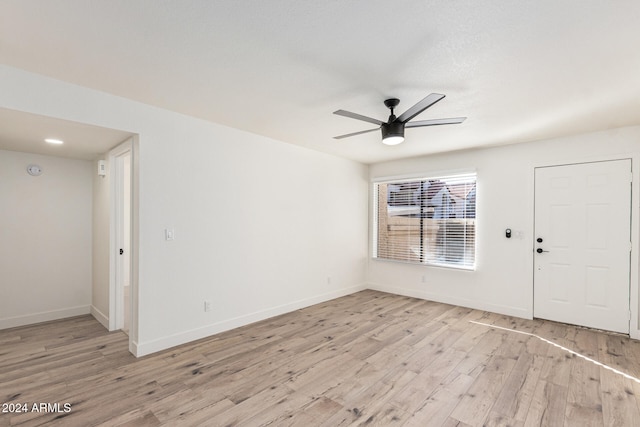 unfurnished room with light wood-type flooring and ceiling fan