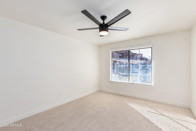 unfurnished room featuring light carpet and ceiling fan