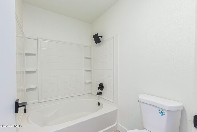 bathroom featuring tub / shower combination and toilet