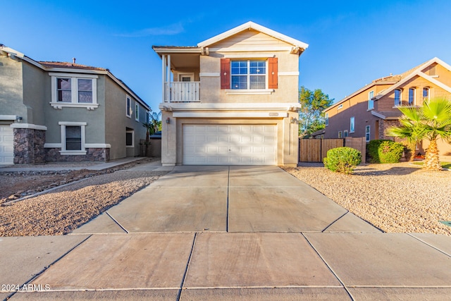 view of property with a balcony and a garage