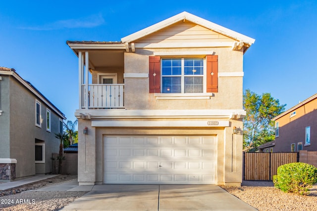 front facade featuring a garage and a balcony