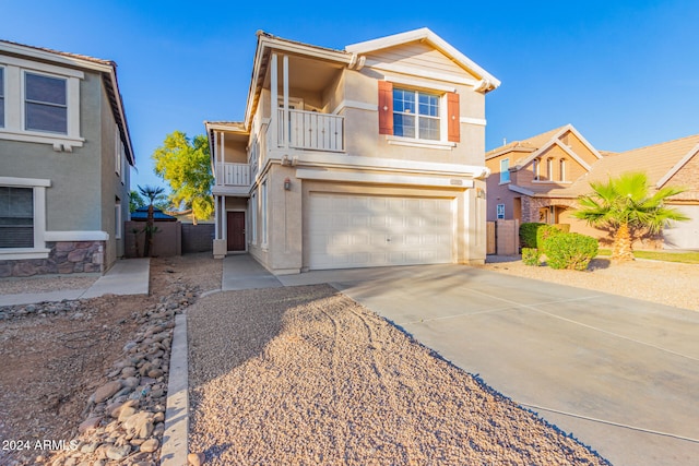 view of front of property with a balcony and a garage