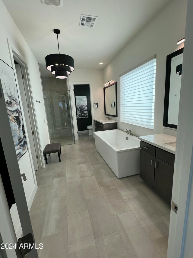 full bathroom with tile patterned floors, vanity, independent shower and bath, and toilet