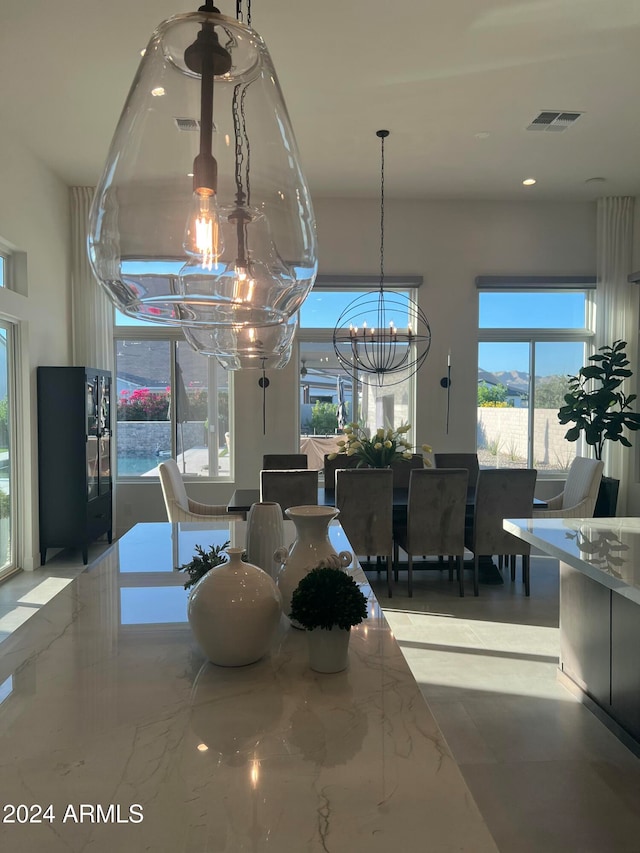 dining area featuring an inviting chandelier and plenty of natural light