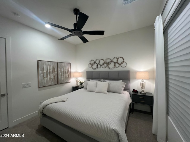 bedroom with dark colored carpet and ceiling fan