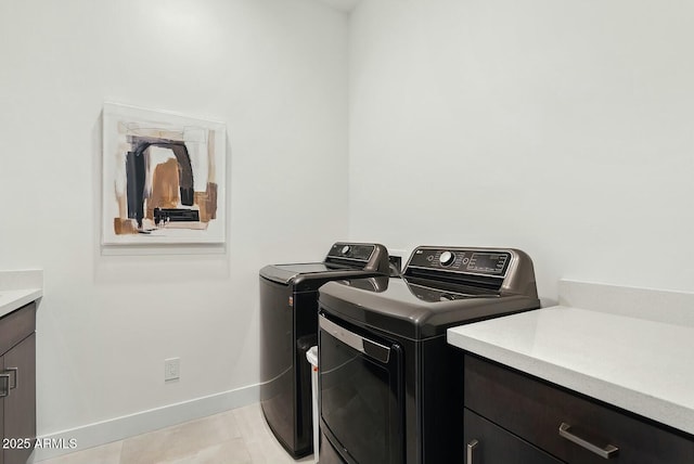 20475 E Indiana Ave, Queen Creek, AZ 85142 - washroom featuring washer and dryer, baseboards, light tile patterned flooring, and cabinet space