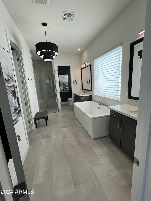 full bathroom with tile patterned flooring, vanity, toilet, and separate shower and tub