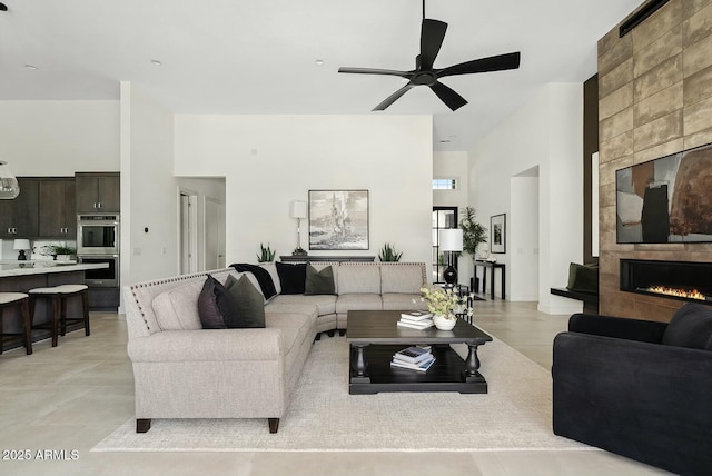 20475 E Indiana Ave, Queen Creek, AZ 85142 - living area with a towering ceiling, a fireplace, and a ceiling fan