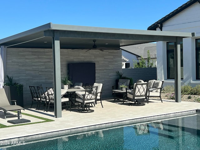 view of swimming pool with a patio area and ceiling fan