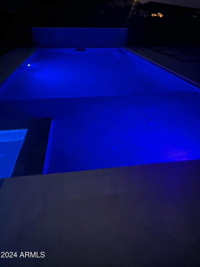 view of pool at night