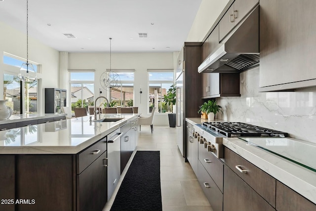 20475 E Indiana Ave, Queen Creek, AZ 85142 - kitchen with a sink, under cabinet range hood, stainless steel appliances, tasteful backsplash, and dark brown cabinetry