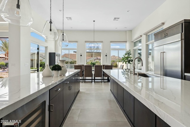 20475 E Indiana Ave, Queen Creek, AZ 85142 - kitchen with a sink, beverage cooler, pendant lighting, light stone countertops, and modern cabinets