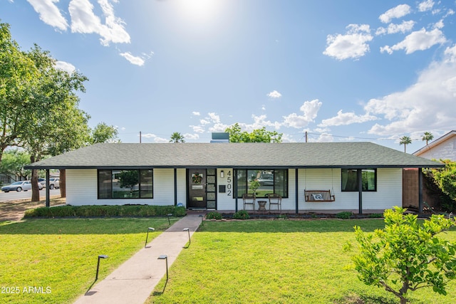 4502 N 17th Ave, Phoenix, AZ 85015 - single story home featuring a porch, roof with shingles, and a front lawn