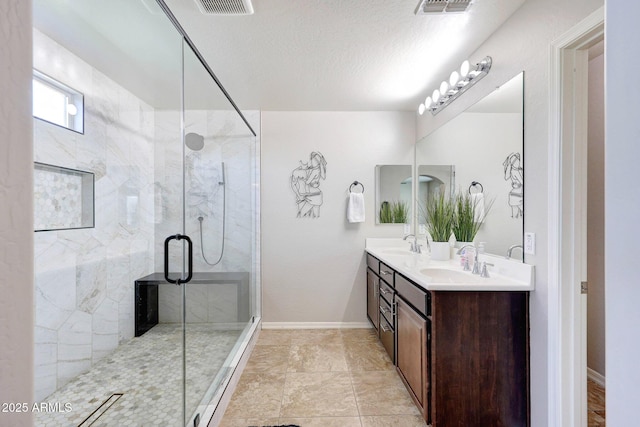 2716 W Sunland Ave, Phoenix, AZ 85041 - full bathroom with double vanity, a shower stall, and baseboards