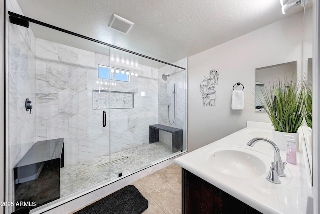 2716 W Sunland Ave, Phoenix, AZ 85041 - bathroom featuring double vanity, a stall shower, and a textured ceiling