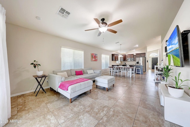 2716 W Sunland Ave, Phoenix, AZ 85041 - living area featuring a ceiling fan, vaulted ceiling, and baseboards