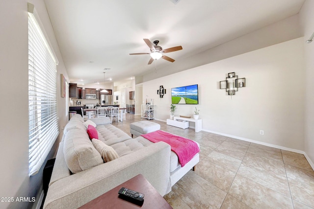 2716 W Sunland Ave, Phoenix, AZ 85041 - living area with a ceiling fan, baseboards, and light tile patterned flooring