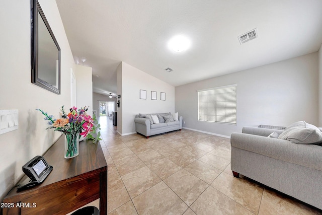 2716 W Sunland Ave, Phoenix, AZ 85041 - living area featuring lofted ceiling, light tile patterned floors, and baseboards