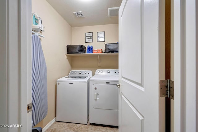 2716 W Sunland Ave, Phoenix, AZ 85041 - washroom with washing machine and clothes dryer, light tile patterned flooring, and baseboards