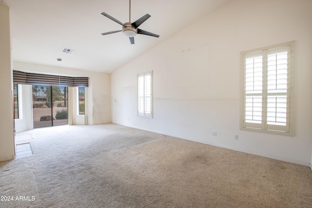 empty room with carpet flooring, a ceiling fan, visible vents, and high vaulted ceiling