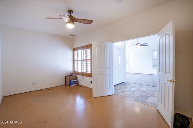 spare room featuring visible vents, baseboards, and a ceiling fan