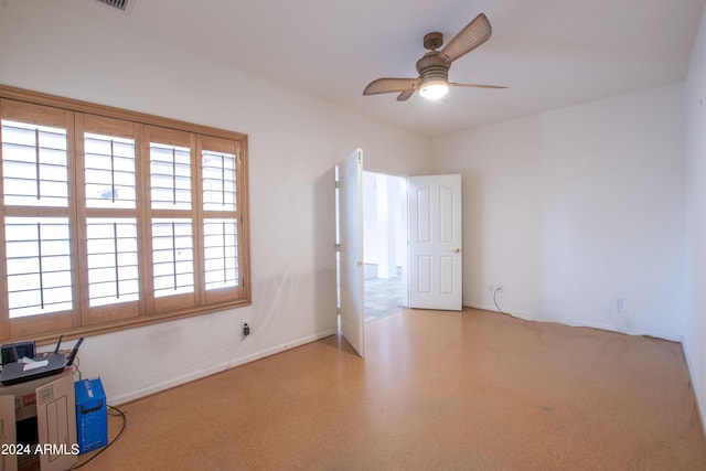 empty room with baseboards and ceiling fan