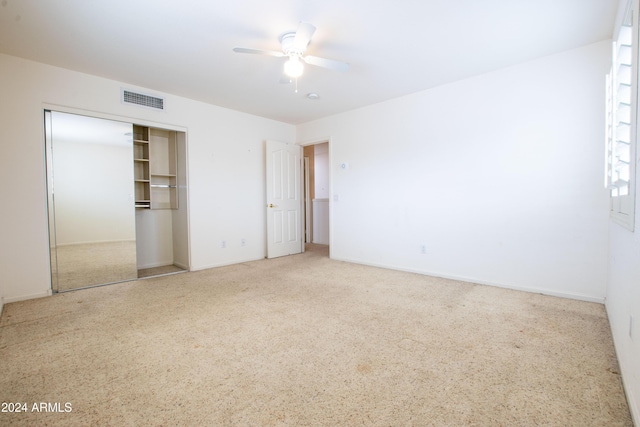 unfurnished bedroom featuring a closet, visible vents, and a ceiling fan