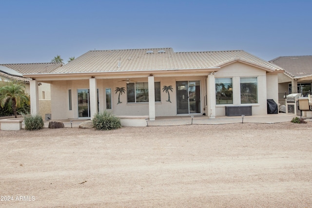 rear view of house featuring a patio area, stucco siding, a tile roof, and ceiling fan