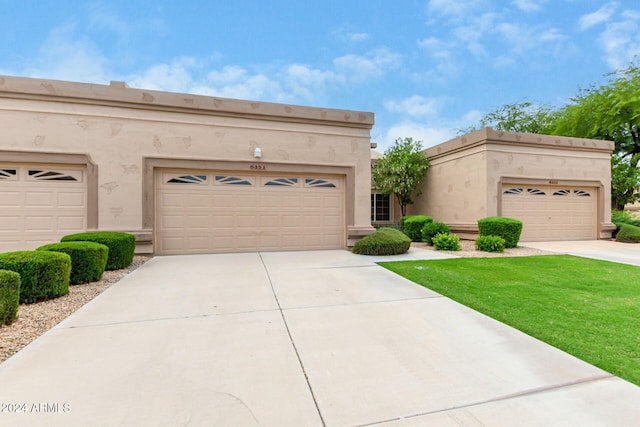 view of front of home with a garage and a front yard