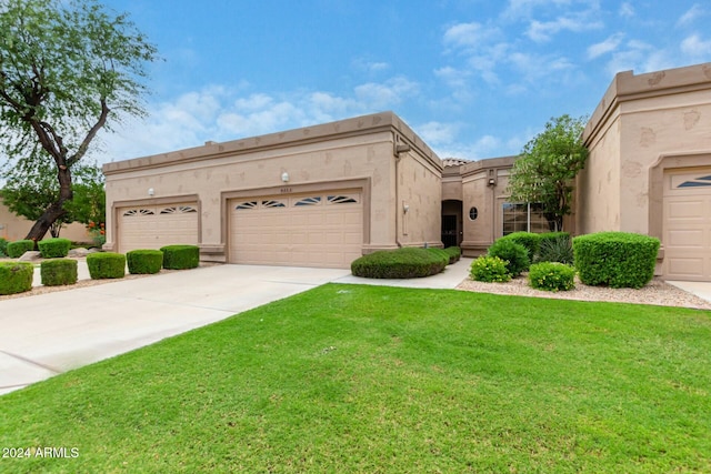 view of front of house with a garage and a front lawn