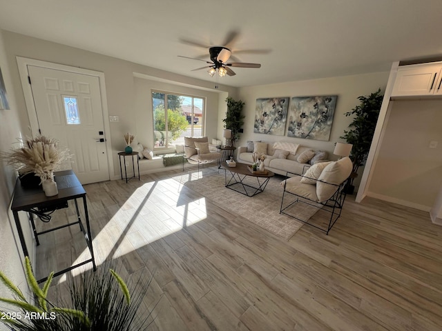 living room featuring light hardwood / wood-style flooring and ceiling fan