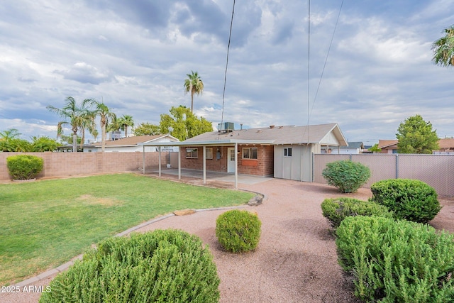 rear view of property with a lawn and a patio area