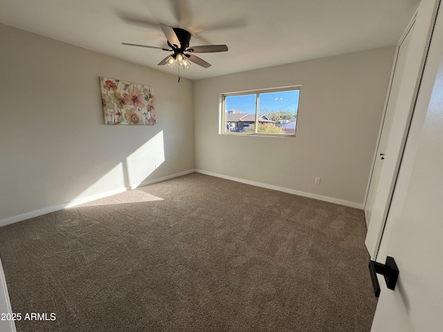 carpeted spare room with ceiling fan