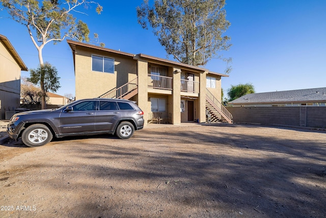 rear view of property with a balcony