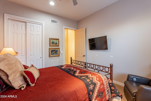 carpeted bedroom featuring ceiling fan and a closet