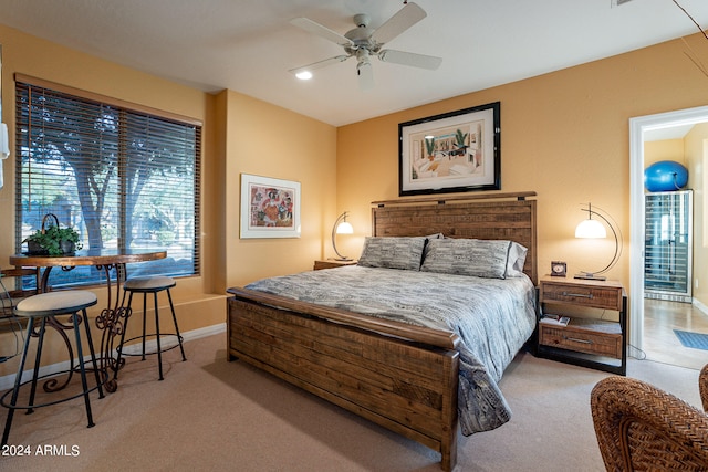 bedroom with ceiling fan and light carpet