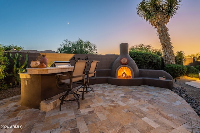 patio terrace at dusk with a bar