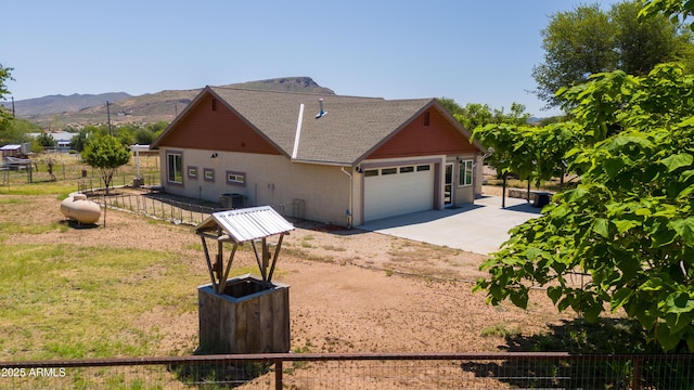 17696 W Foothill Rd, Yarnell, AZ 85362 - view of front facade featuring driveway, a garage, and a mountain view
