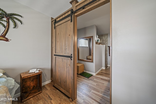 17696 W Foothill Rd, Yarnell, AZ 85362 - corridor with a barn door, wood finished floors, and vaulted ceiling