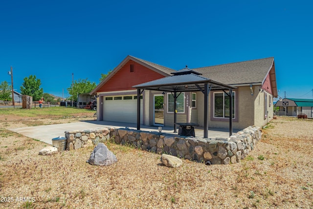 17696 W Foothill Rd, Yarnell, AZ 85362 - view of front of home with a garage, a gazebo, concrete driveway, a patio, and a shingled roof