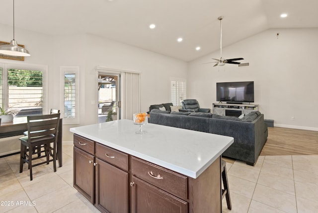 21335 N 64th Ave, Glendale, AZ 85308 - kitchen with light countertops, vaulted ceiling, a ceiling fan, and light tile patterned flooring