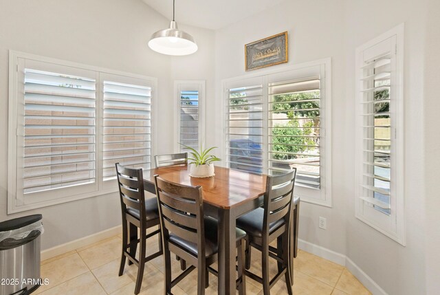 21335 N 64th Ave, Glendale, AZ 85308 - dining room with baseboards, light tile patterned flooring, and lofted ceiling