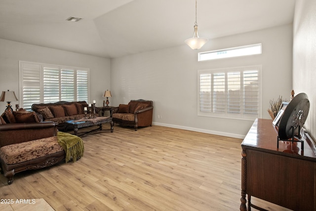 21335 N 64th Ave, Glendale, AZ 85308 - living room featuring light wood finished floors, visible vents, baseboards, and vaulted ceiling