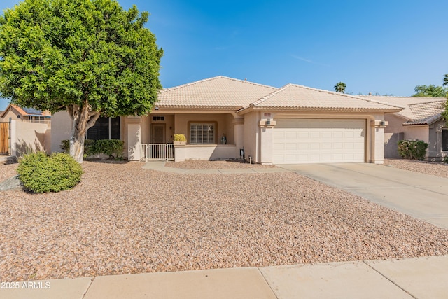 21335 N 64th Ave, Glendale, AZ 85308 - view of front of house with an attached garage, a tiled roof, driveway, and stucco siding