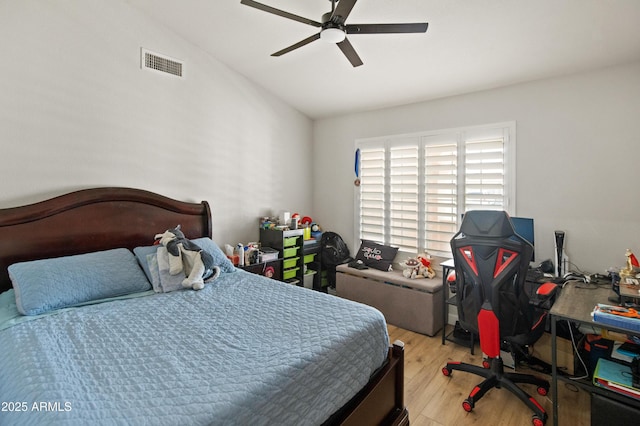 21335 N 64th Ave, Glendale, AZ 85308 - bedroom with wood finished floors, ceiling fan, vaulted ceiling, and visible vents