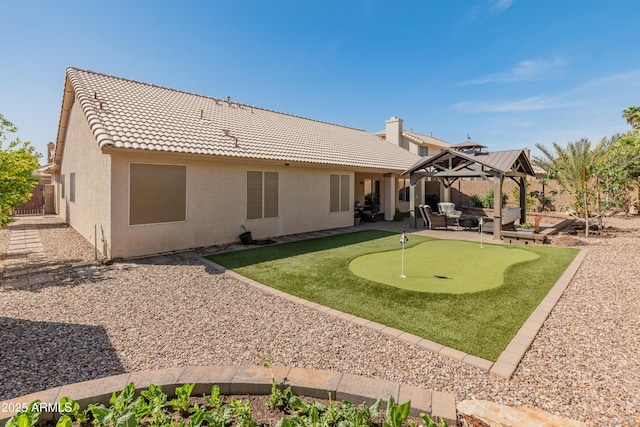 21335 N 64th Ave, Glendale, AZ 85308 - back of house featuring stucco siding, a patio area, a gazebo, a tiled roof, and fence