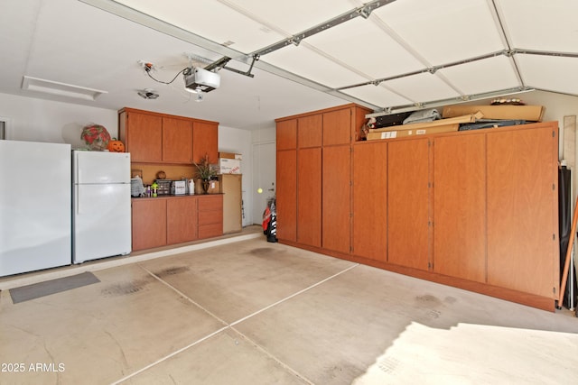 21335 N 64th Ave, Glendale, AZ 85308 - garage featuring a garage door opener and freestanding refrigerator