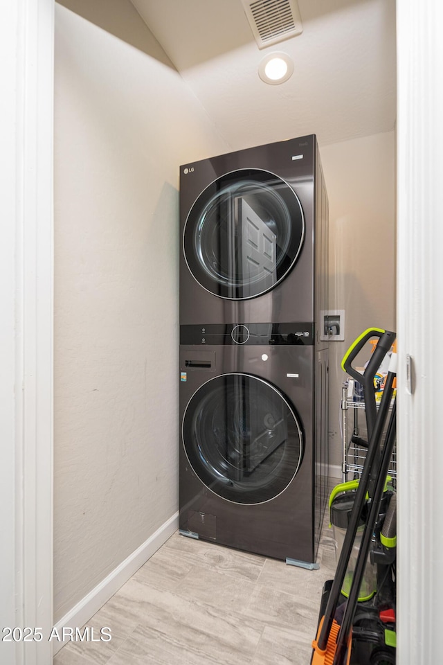 laundry room with stacked washer and dryer