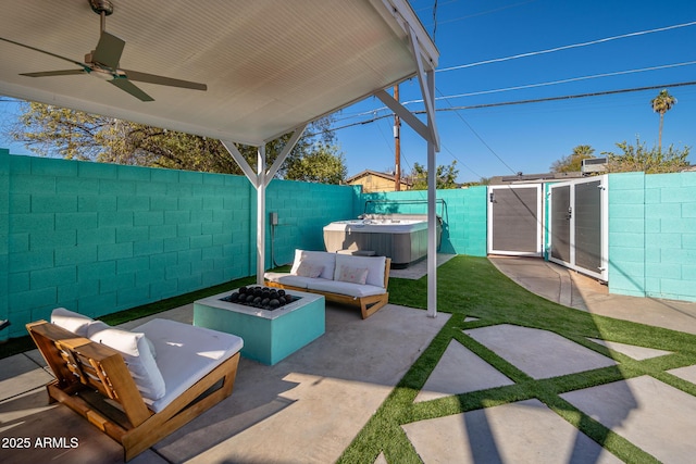 view of patio / terrace featuring ceiling fan, a hot tub, and outdoor lounge area