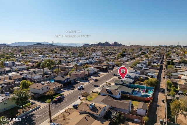 birds eye view of property with a mountain view